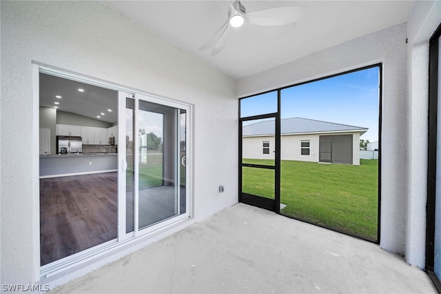 unfurnished sunroom featuring lofted ceiling and ceiling fan