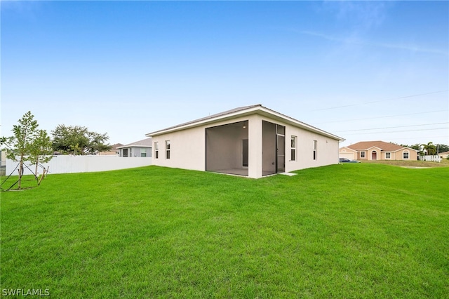 rear view of house with a lawn