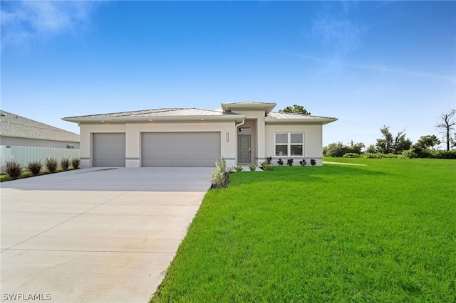 prairie-style house with a garage and a front lawn