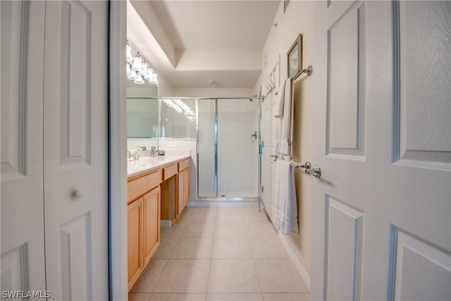 bathroom with an enclosed shower, vanity, and tile patterned floors