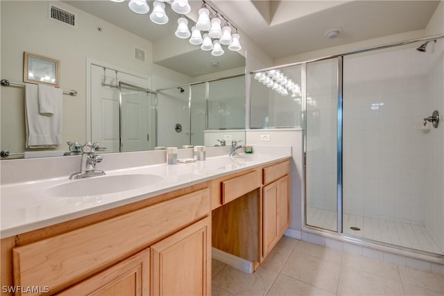 bathroom with tile patterned flooring, vanity, and a shower with shower door