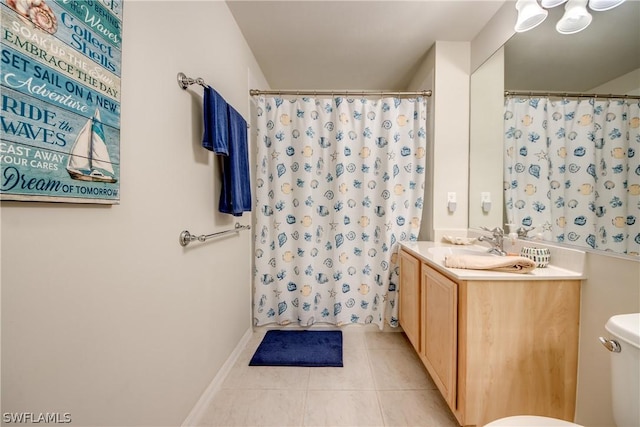 bathroom with tile patterned flooring, vanity, and toilet