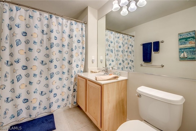 bathroom with tile patterned floors, toilet, curtained shower, and vanity