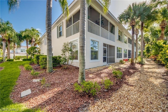 view of side of property with ceiling fan