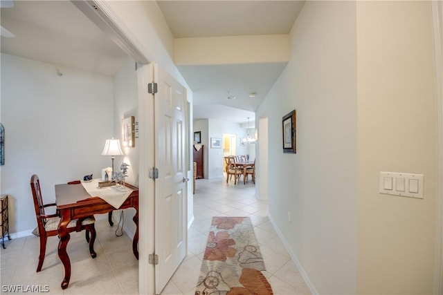 hall with lofted ceiling and light tile patterned floors