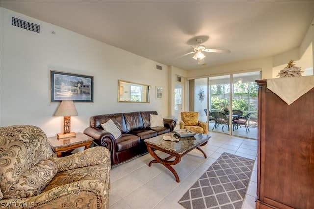 tiled living room with ceiling fan