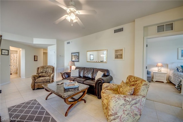 living room featuring light tile patterned flooring and ceiling fan