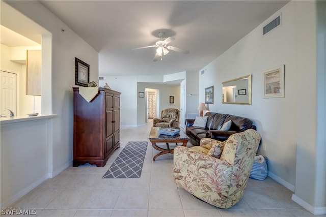 tiled living room featuring ceiling fan