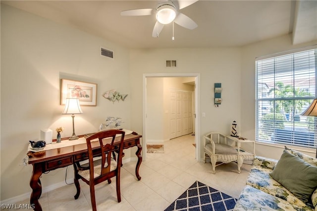 tiled home office featuring ceiling fan