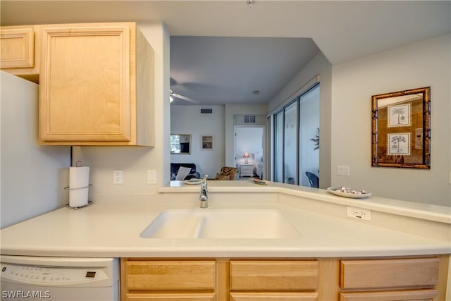 kitchen with ceiling fan, sink, light brown cabinets, and white dishwasher