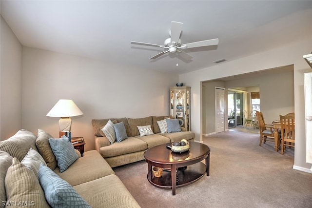 living room featuring carpet and ceiling fan