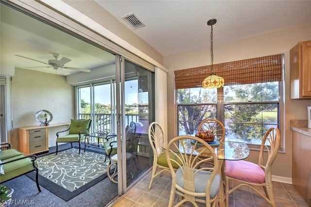 dining space featuring ceiling fan and light tile patterned floors