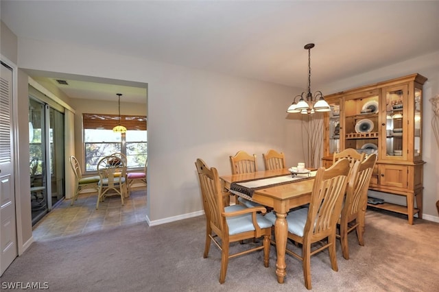 dining room featuring an inviting chandelier and carpet