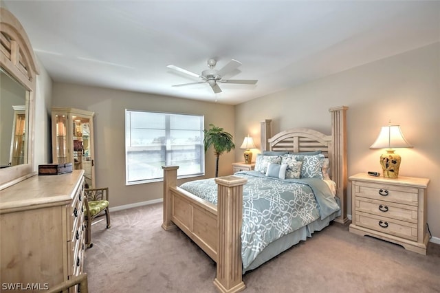 bedroom featuring light colored carpet and ceiling fan