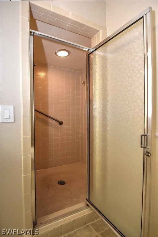 bathroom with a shower with door