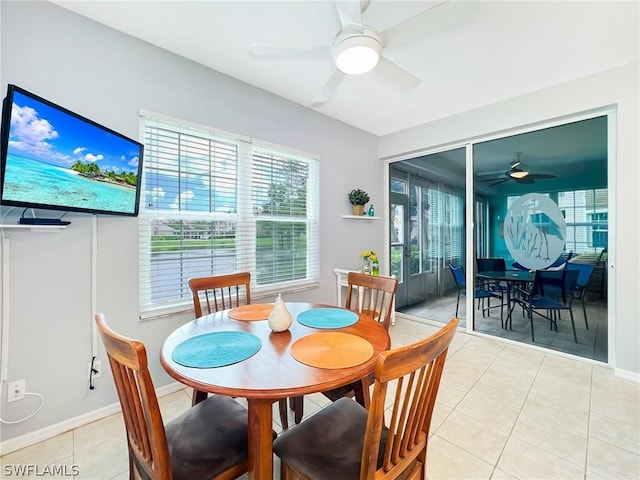 dining space featuring ceiling fan and light tile patterned flooring