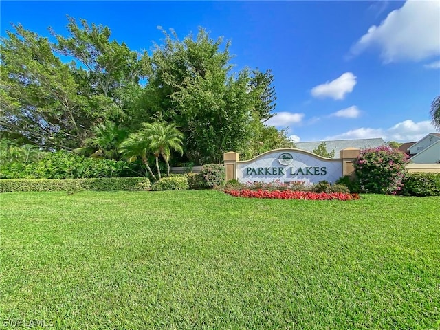 community / neighborhood sign featuring a lawn