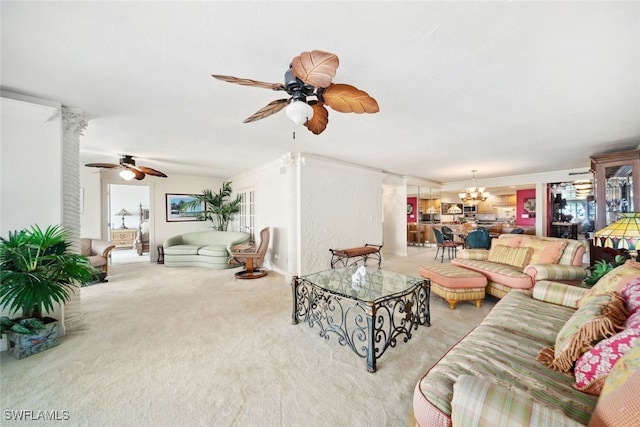 carpeted living room with ceiling fan with notable chandelier