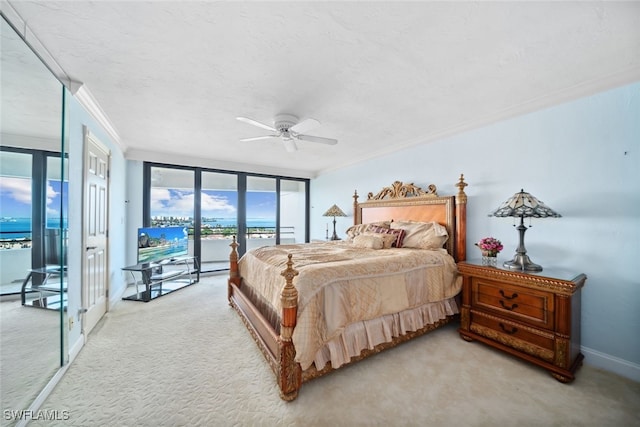 carpeted bedroom with a textured ceiling, access to exterior, ceiling fan, and ornamental molding