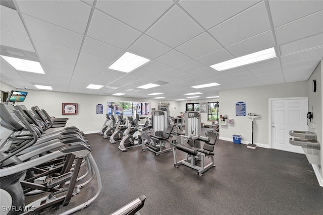 workout area featuring a wealth of natural light and a drop ceiling