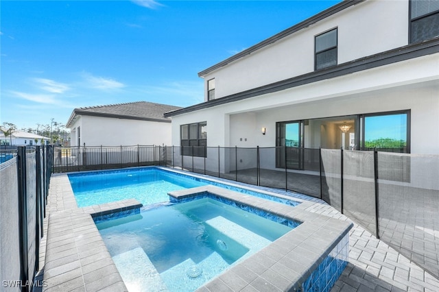 view of swimming pool with an in ground hot tub