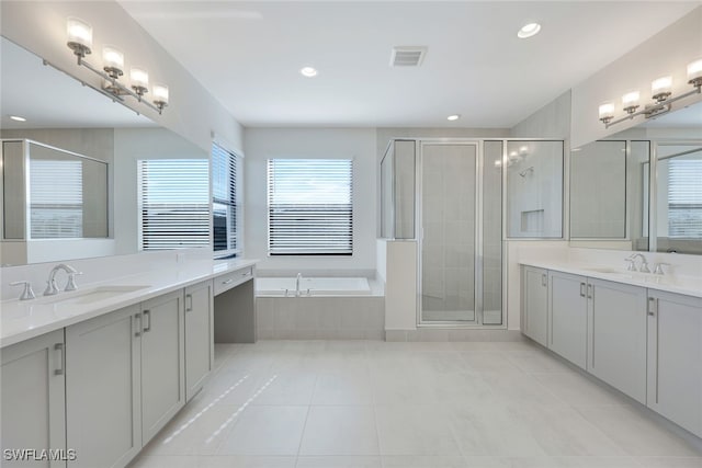 bathroom featuring tile patterned floors, vanity, and separate shower and tub