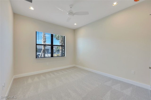 carpeted spare room featuring ceiling fan