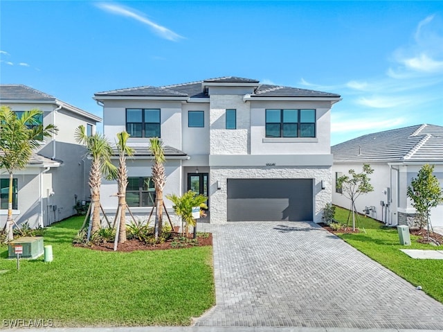 view of front of property featuring a garage and a front yard