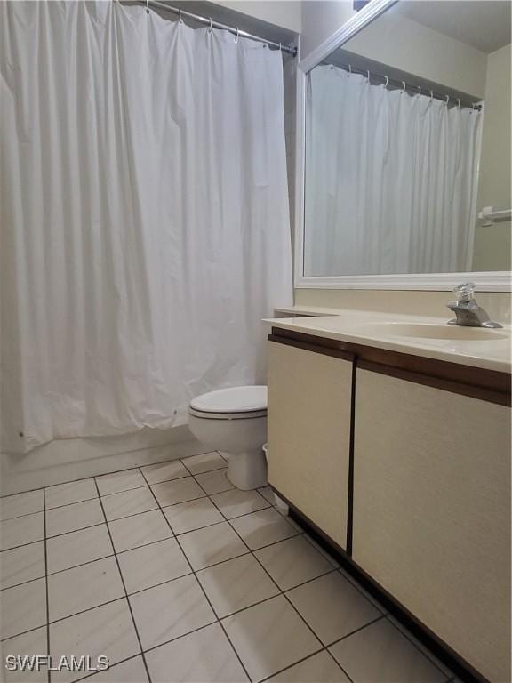 full bathroom with toilet, tile patterned flooring, vanity, and shower / tub combo with curtain