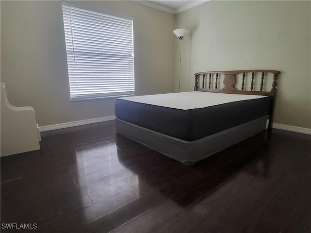 bedroom featuring dark hardwood / wood-style flooring and ornamental molding