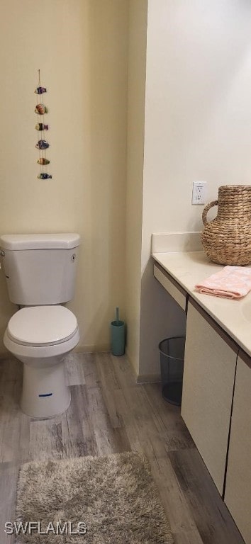 bathroom featuring toilet and wood finished floors