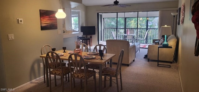 carpeted dining room featuring a ceiling fan