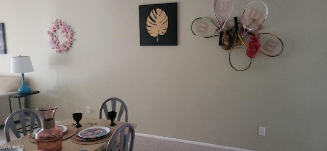 dining area with carpet and baseboards