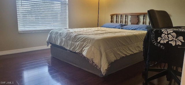 bedroom with wood finished floors and baseboards