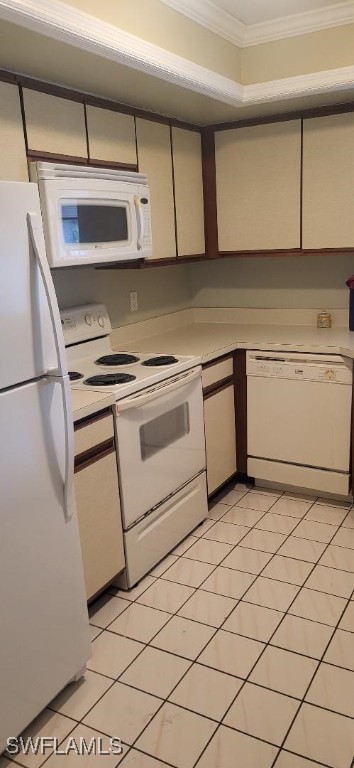 kitchen with white appliances, light countertops, and crown molding