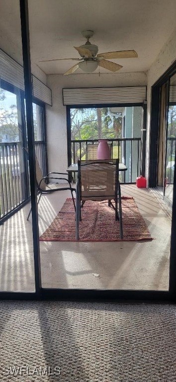 sunroom / solarium with a ceiling fan and a wealth of natural light