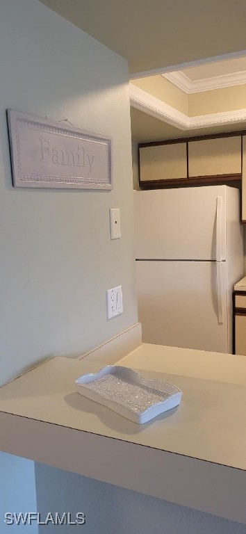 room details featuring ornamental molding and freestanding refrigerator