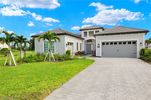 view of front of property featuring a garage and a front lawn