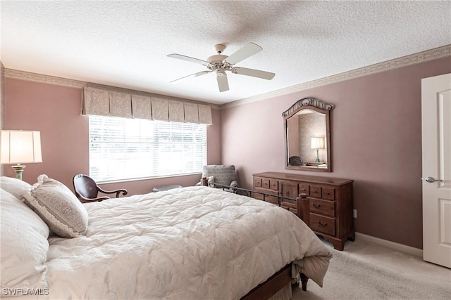 carpeted bedroom featuring ceiling fan and a textured ceiling