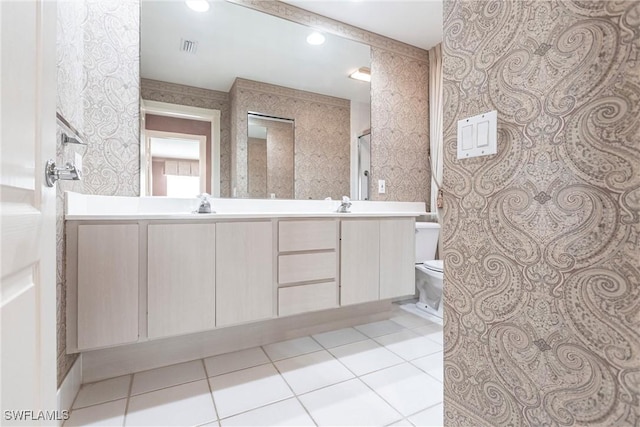 bathroom with tile patterned flooring, vanity, and toilet