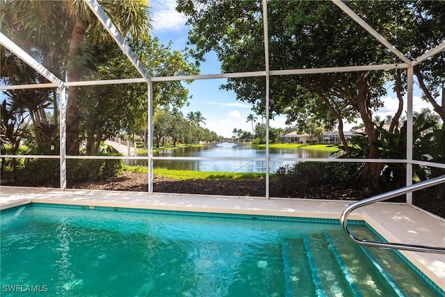 view of swimming pool featuring a water view and a lanai