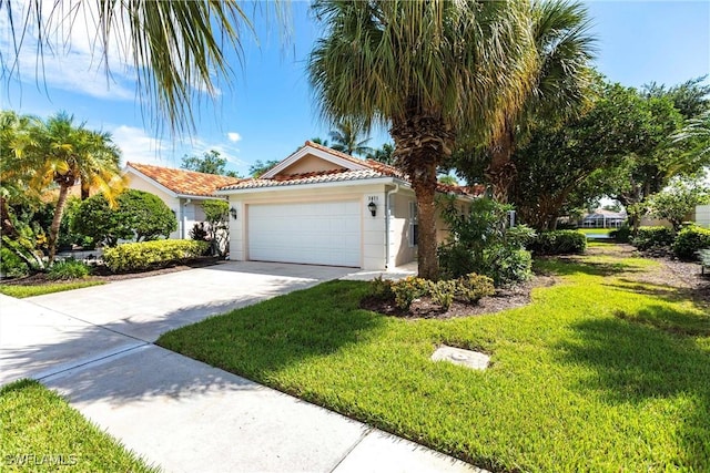 view of front of home with a front yard and a garage