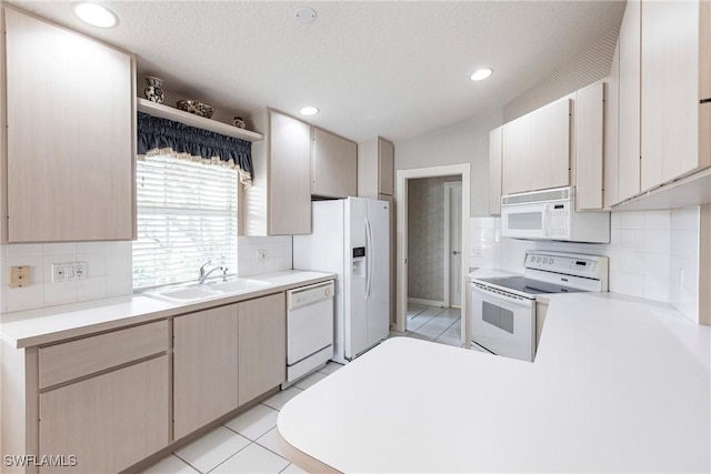 kitchen with sink, light brown cabinets, tasteful backsplash, white appliances, and light tile patterned floors