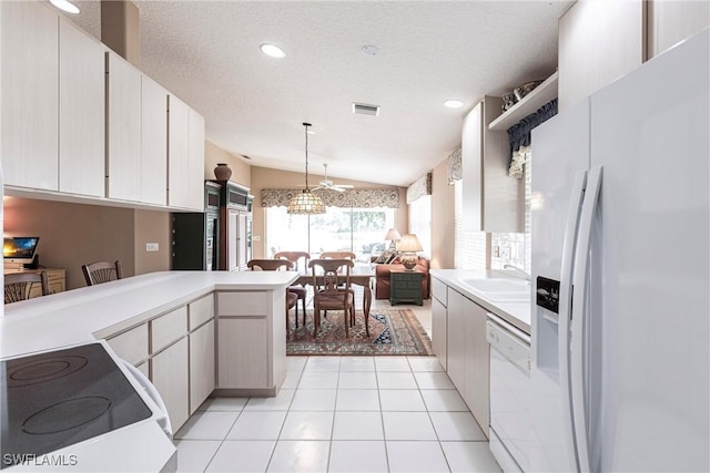 kitchen with white appliances, sink, hanging light fixtures, vaulted ceiling, and kitchen peninsula