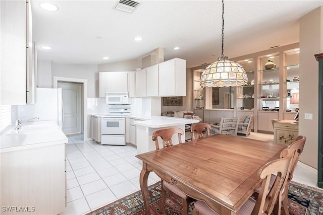 tiled dining area featuring sink