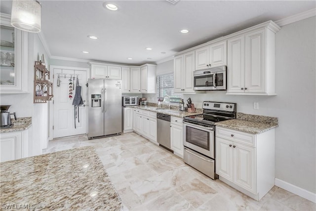 kitchen featuring sink, crown molding, white cabinetry, stainless steel appliances, and light stone countertops