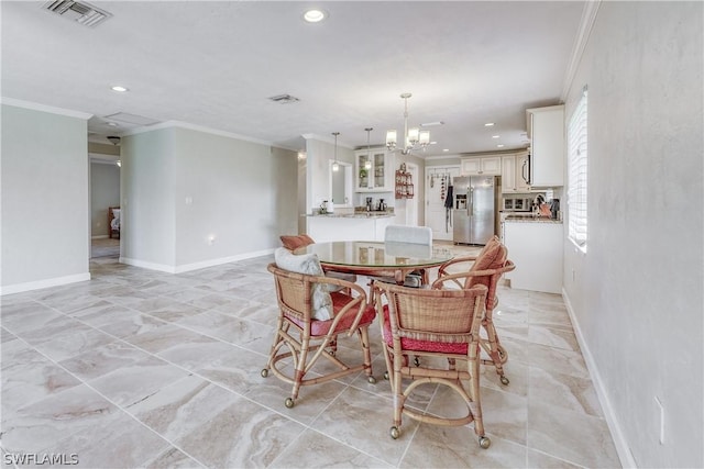 dining space featuring crown molding and a notable chandelier