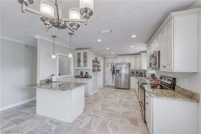 kitchen with appliances with stainless steel finishes, light stone countertops, hanging light fixtures, and white cabinets