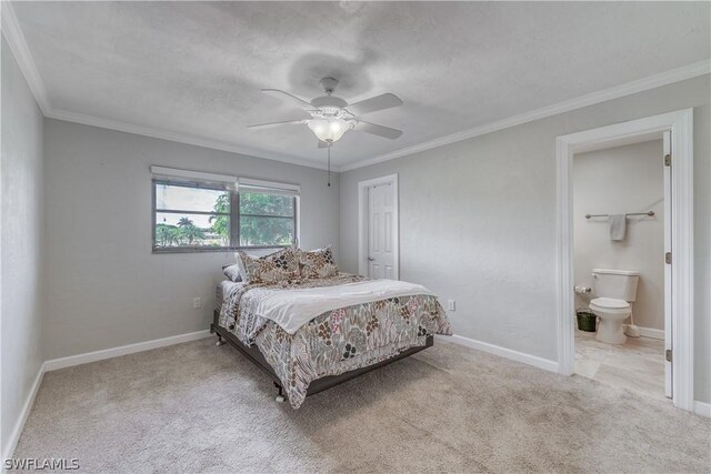 carpeted bedroom featuring ceiling fan, ornamental molding, connected bathroom, and a textured ceiling