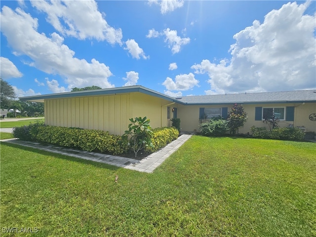 view of property exterior featuring a lawn